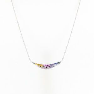 Silver necklace with a curved pendant set with multicolored stones on a white background