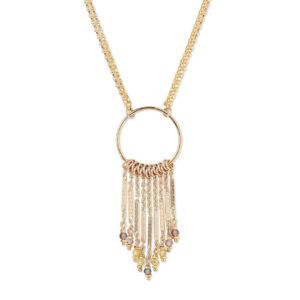 Gold necklace with a circular pendant and hanging fringe tassels