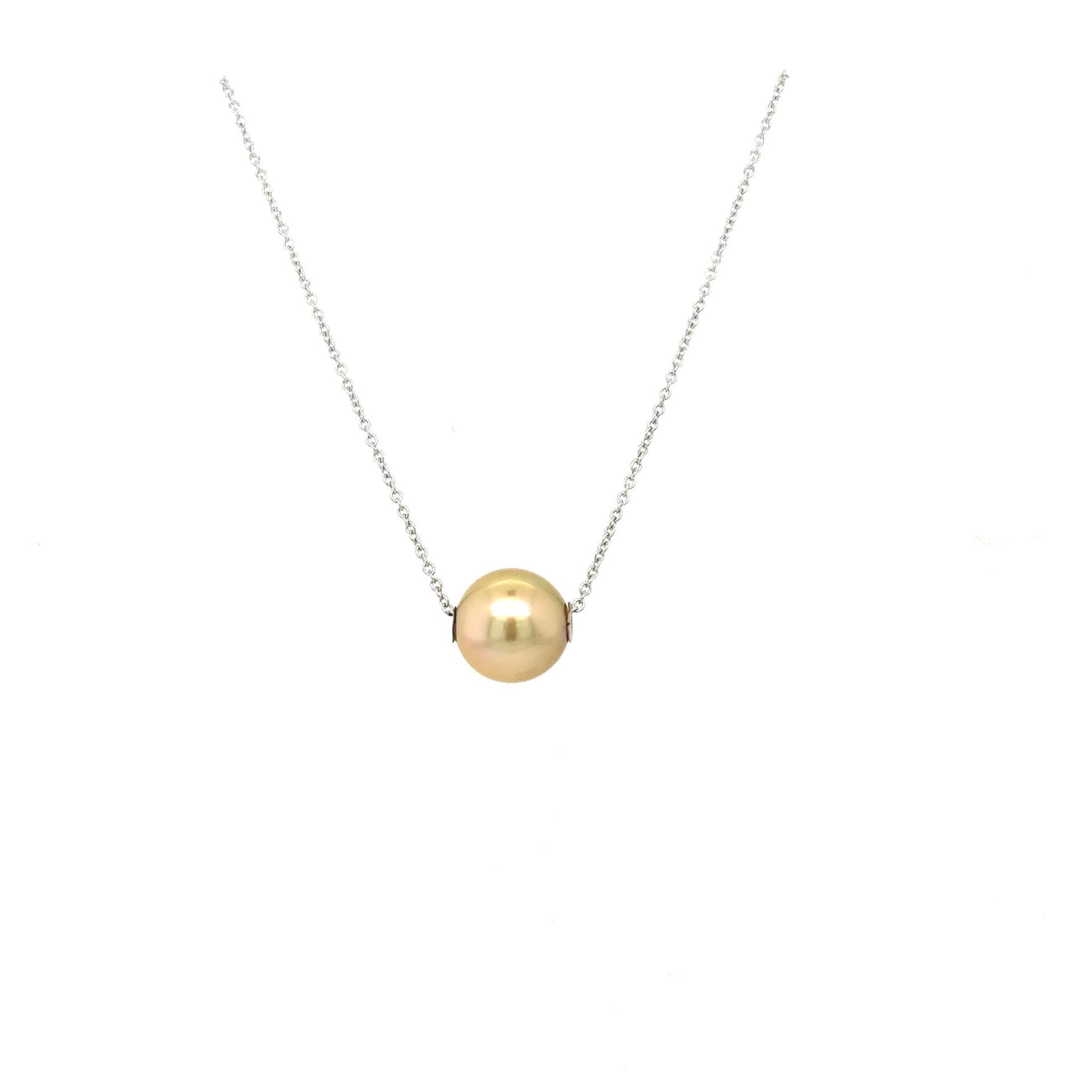 Gold pearl pendant necklace on a thin silver chain
