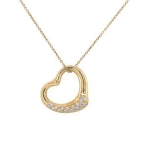 Gold heart-shaped pendant necklace with small clear stones on white background