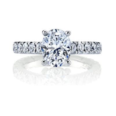 Oval diamond engagement ring with pavé band on a white background