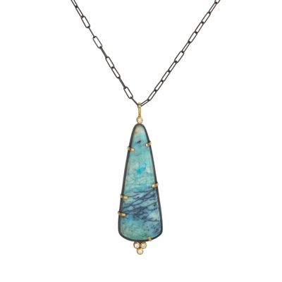 Blue teardrop gemstone pendant on a delicate chain necklace