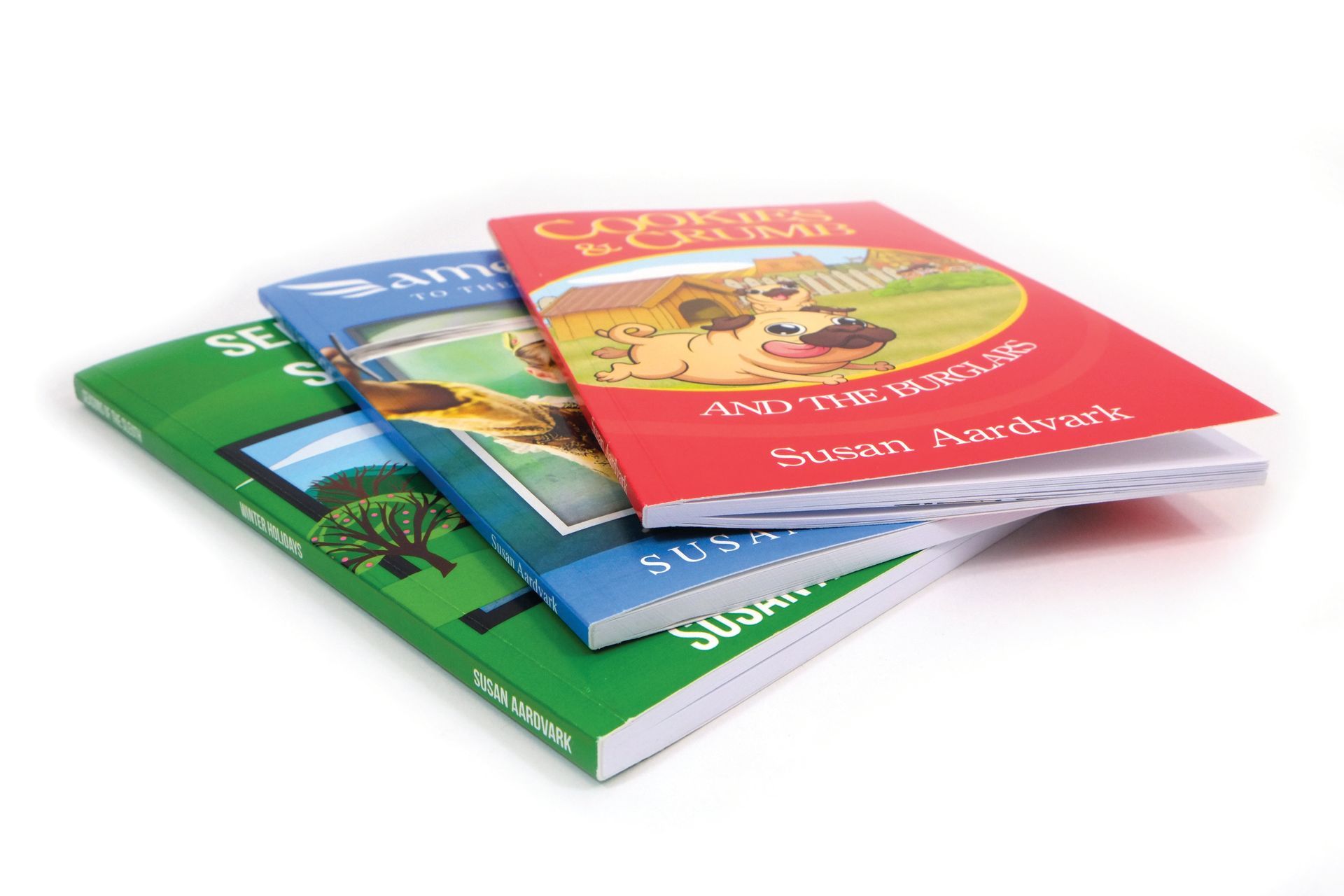 Three colorful children's books stacked. Titles include 