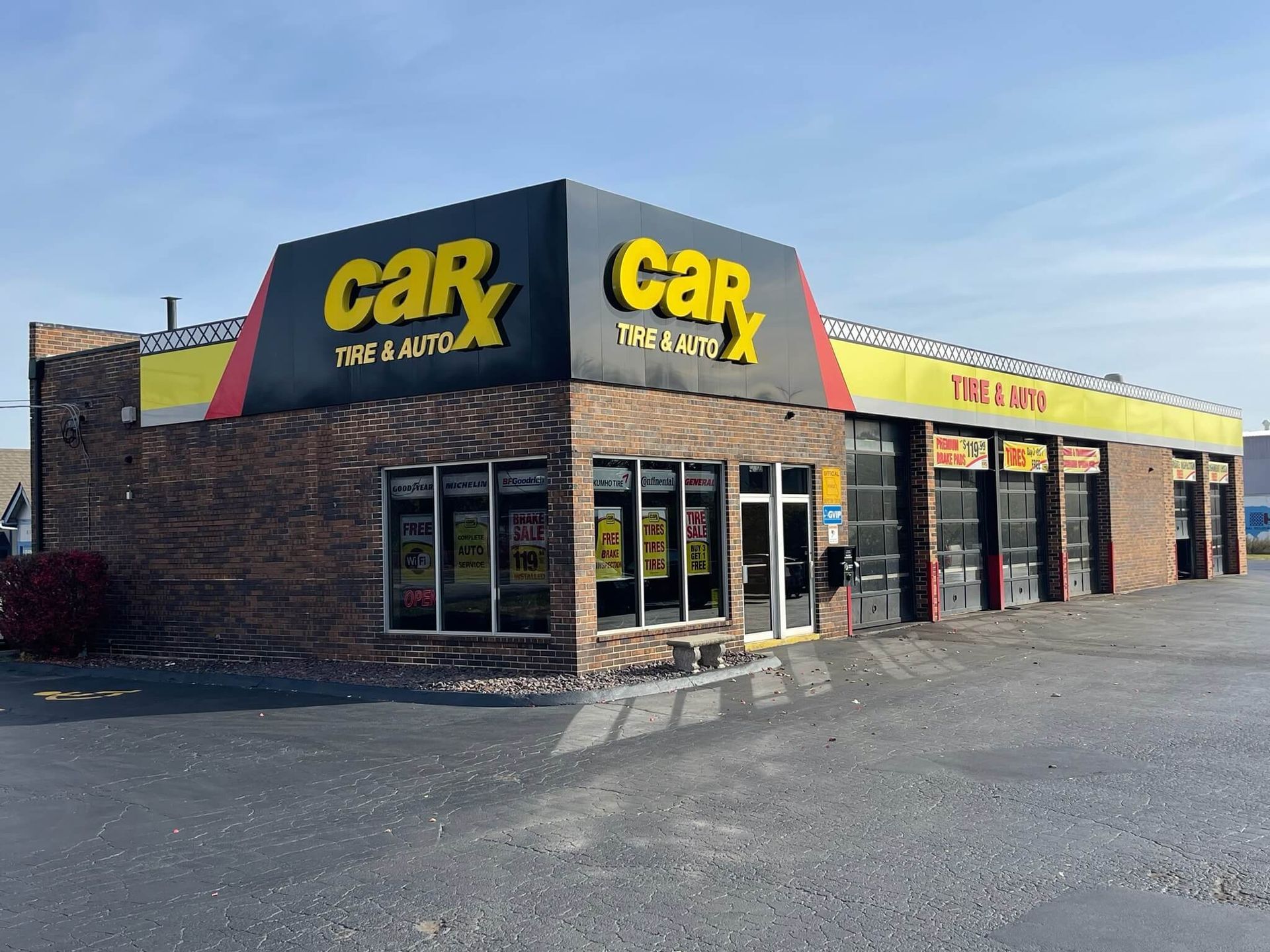 CarX Tire & Auto shop with brick exterior and large yellow and black signage.