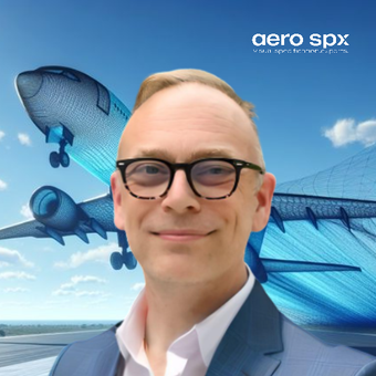 A man wearing glasses is smiling in front of an aero spx logo