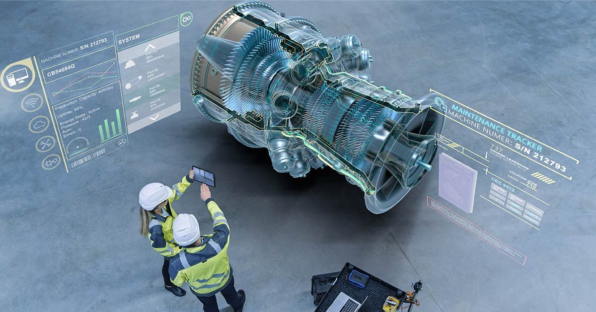 Two engineers are working on a futuristic engine in a factory.