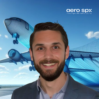 A man with a beard is smiling in front of an aero spx logo