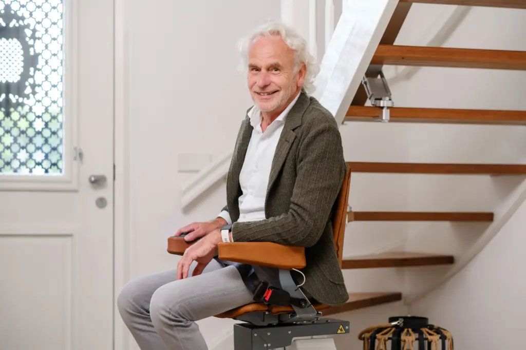 A man is sitting in a chair on a set of stairs.