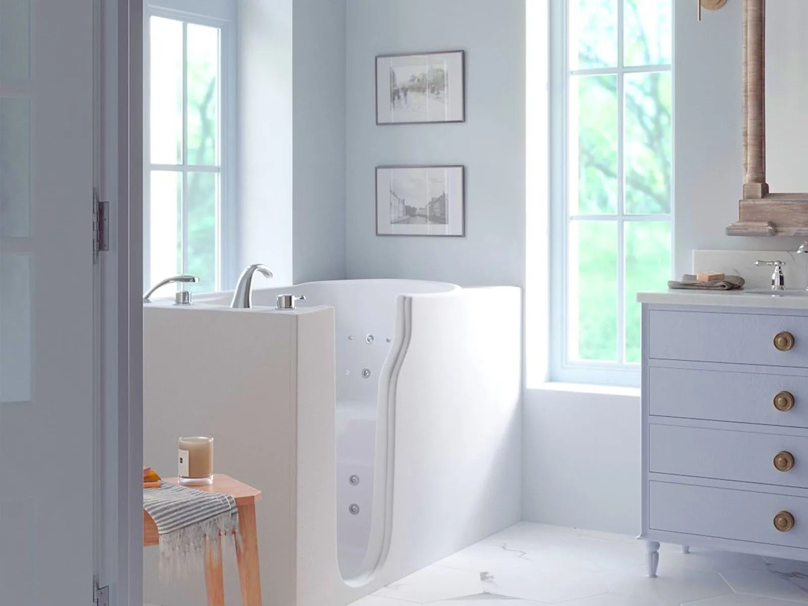 A bathroom with a tub , sink , mirror and dresser.