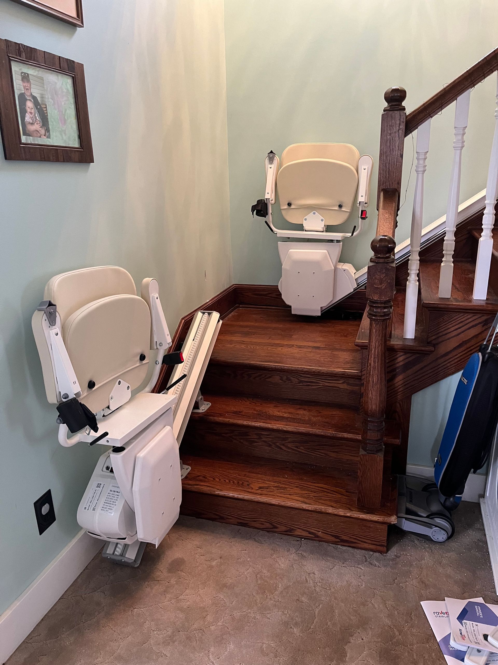 A stair lift is sitting on top of a set of wooden stairs.