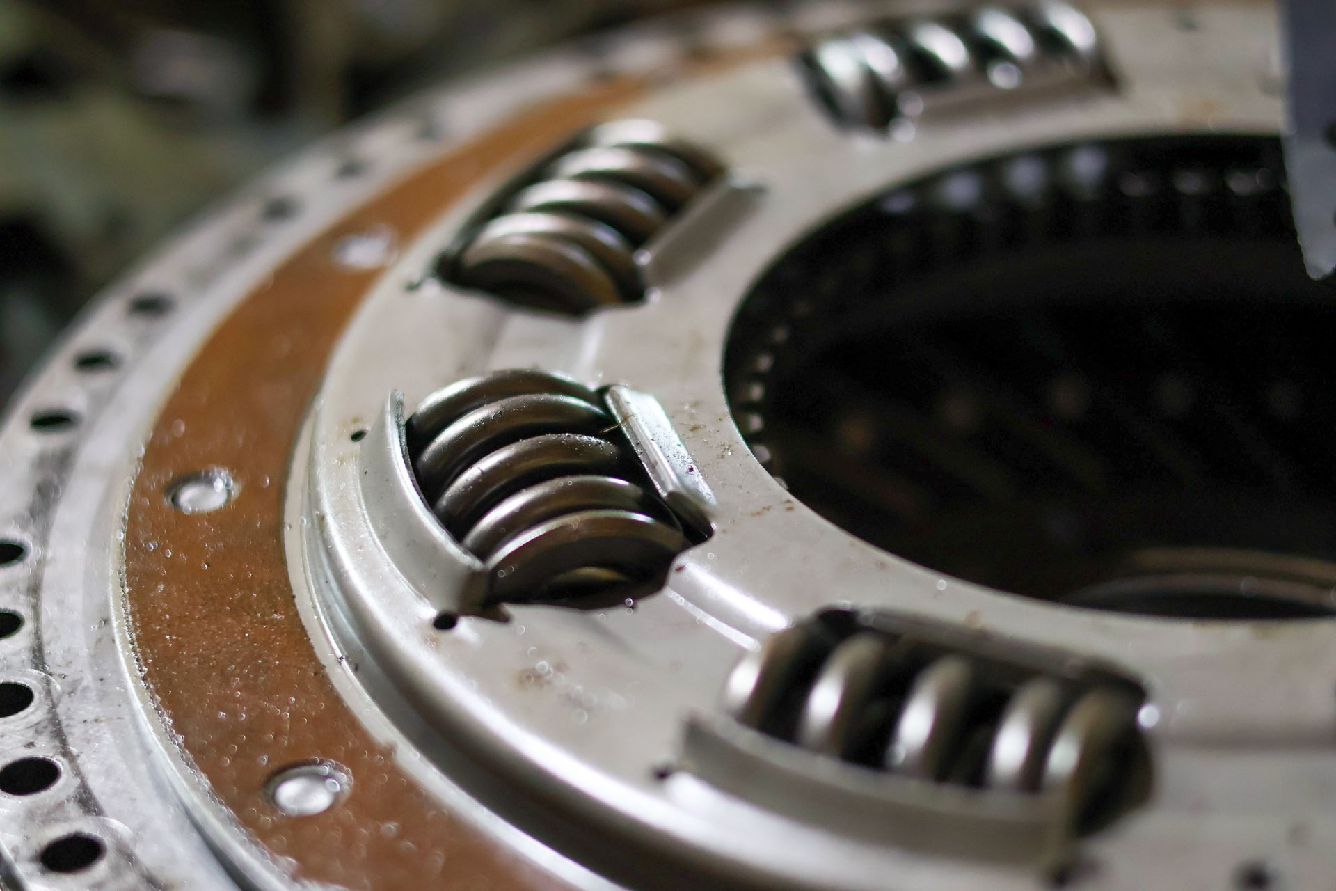 Close up of a heavy-duty automotive clutch disc with visible torsion springs. Close up of a heavy-duty automotive clutch disc with visible torsion springs.