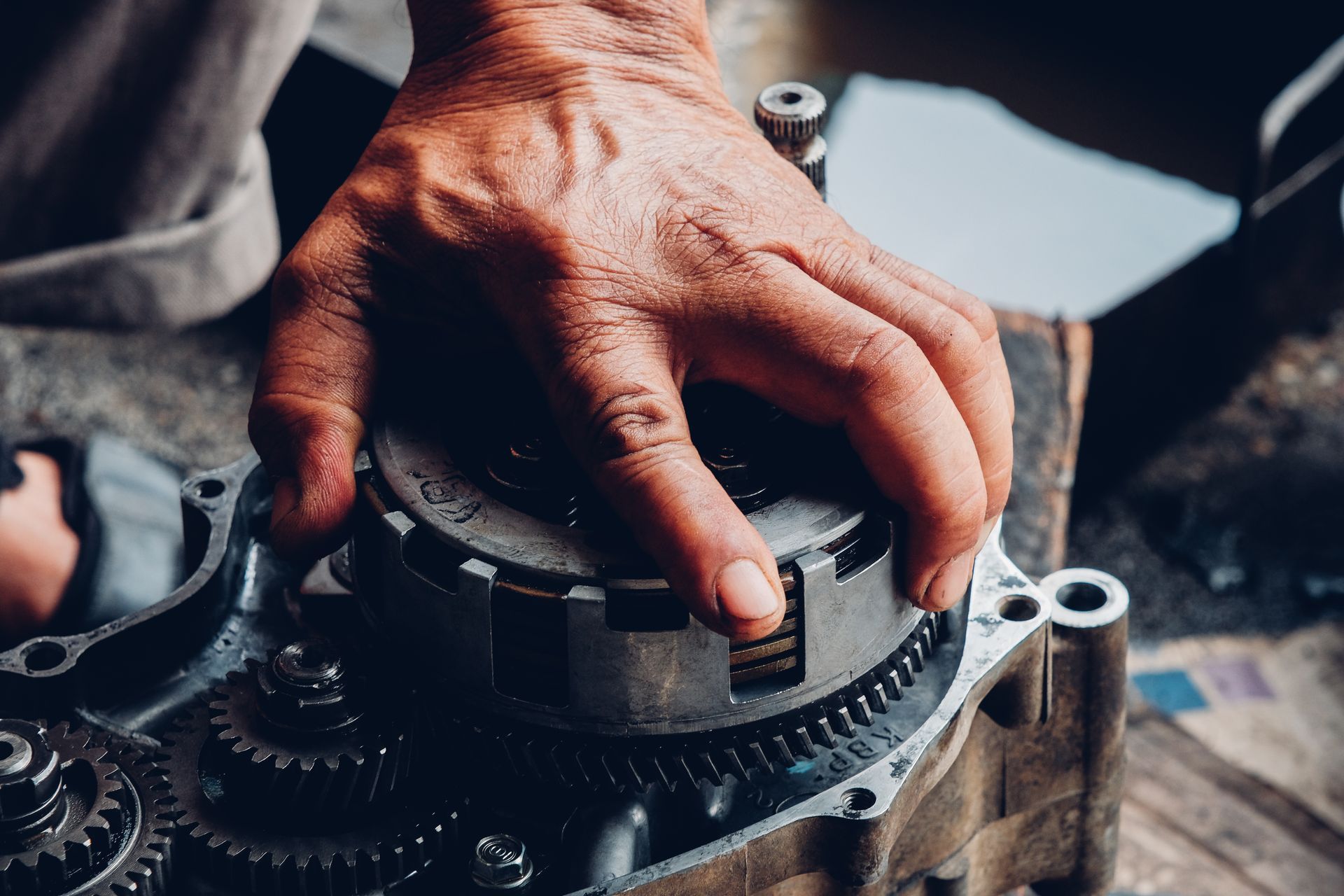Maintenance of motorcycle engine clutch system by a technician.