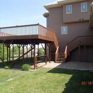 A picture of a house with a deck and stairs taken on 05/18