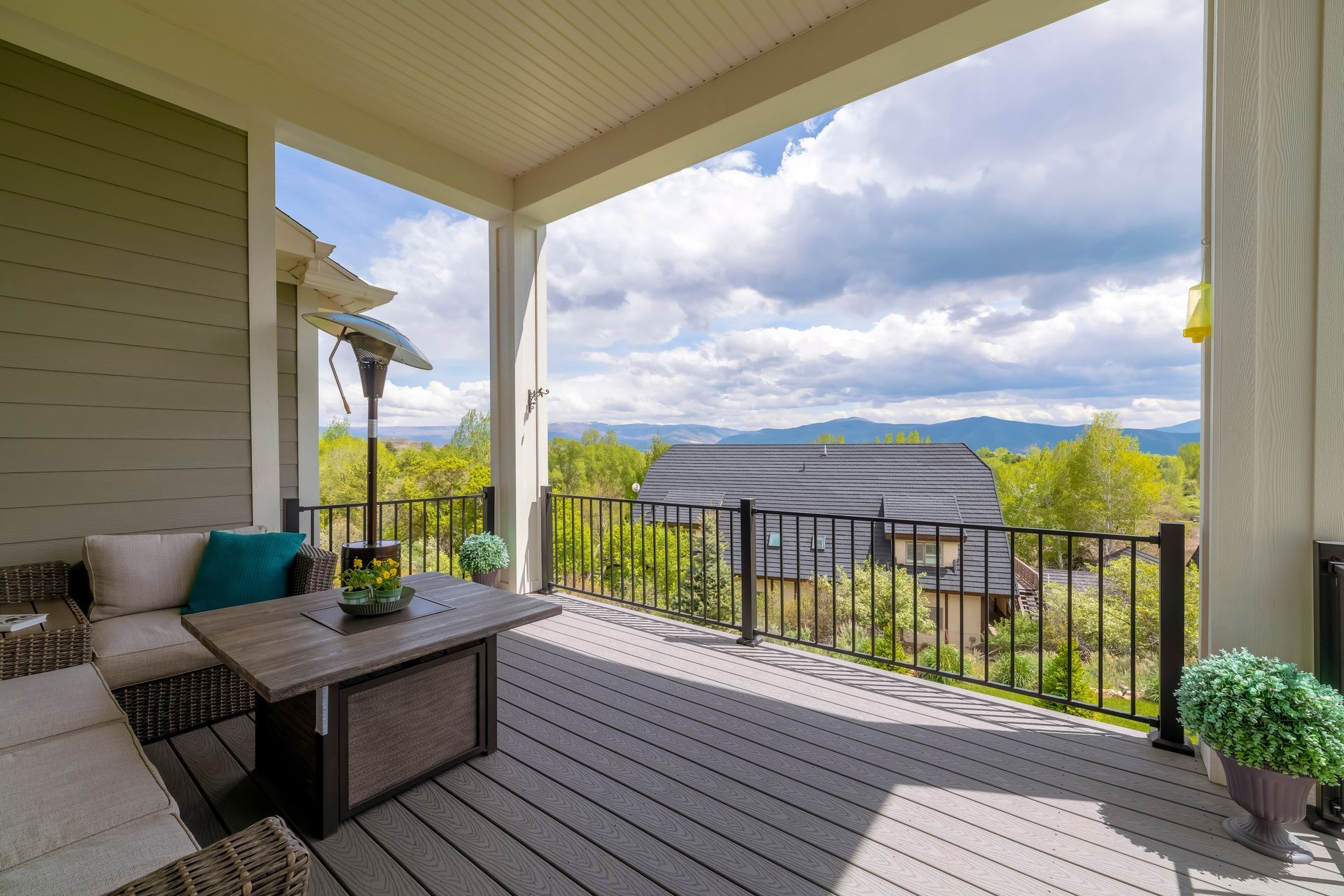 there is a large porch with a view of the mountains .