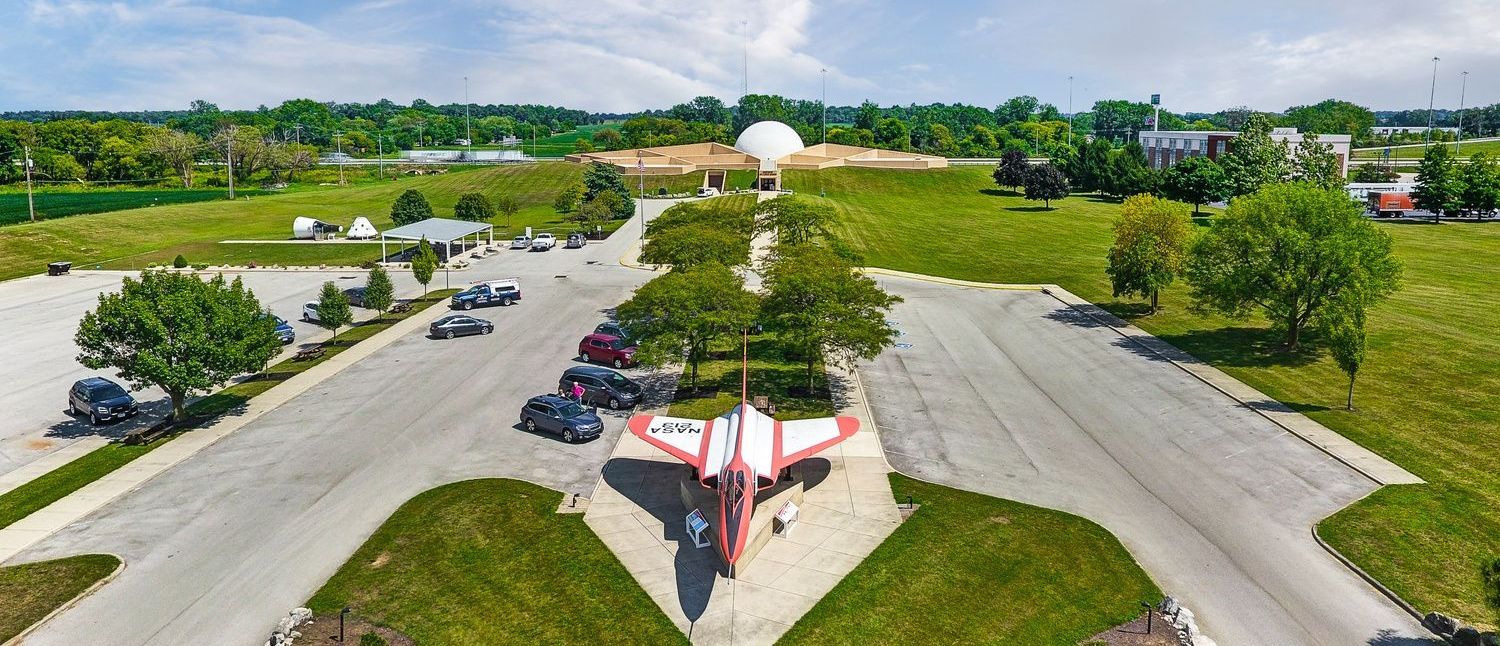 An aerial view of a plane parked outside of the Armstrong Air & Space Museum.