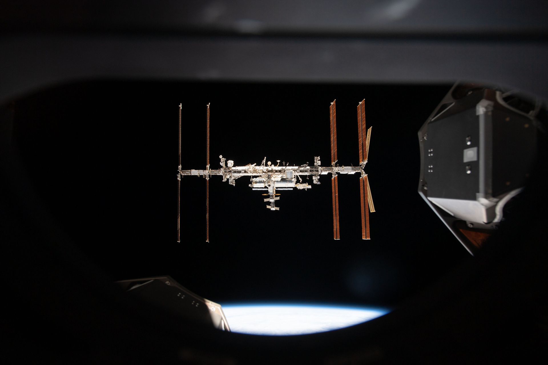 An image of the International Space Station taken from an approaching SpaceX capsule.