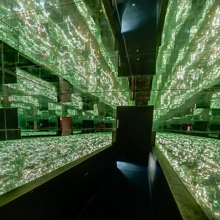 The Infinity Room with a lot of green lights on the walls.