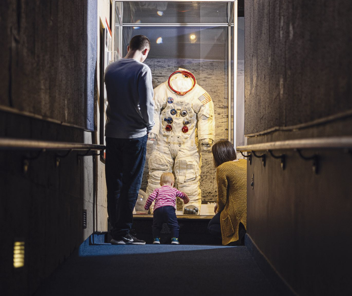 Neil Armstrong's Apollo 11 space suit is displayed in a glass case.