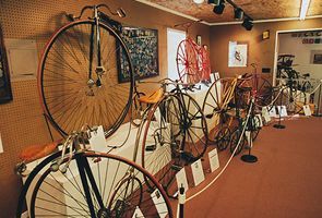 A row of old bicycles are on display in the Bicycle Museum of America.