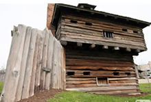The Fort Recovery State Museum features a large wooden building with a wooden fence around it.