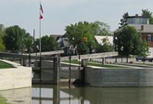 The historic Miami and Erie Canal in New Bremen, Ohio -- with a flag flying in the background.