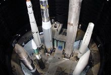 A group of rockets are sitting next to each other in a dark area. The National Aviation Heritage Area.