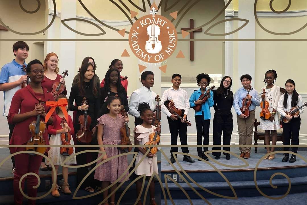 A group of young students holding violins with a banner that says Koart Academy of Music