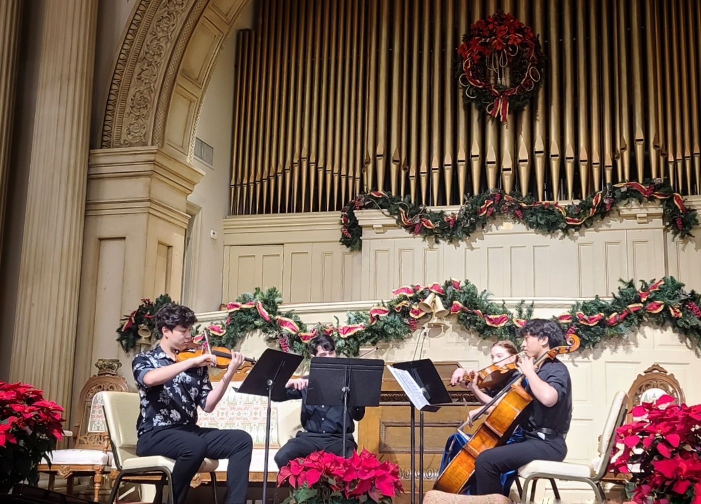 A group of Koart Academy students are playing instruments on a stage.