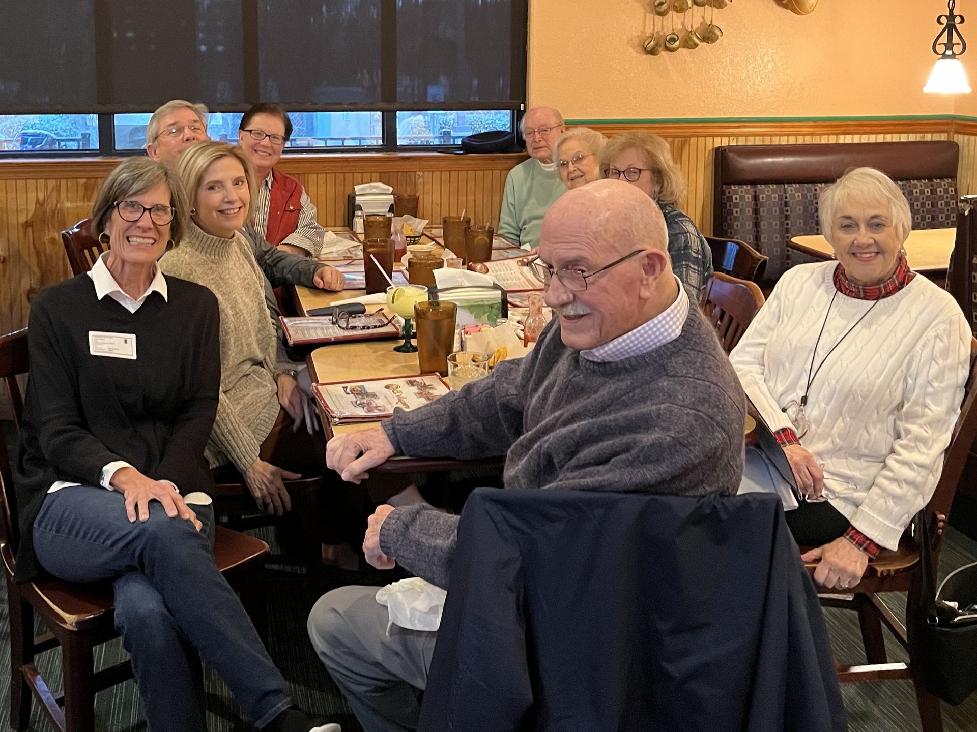 A group of adults sitting around a table at a local Mexican restaurant.