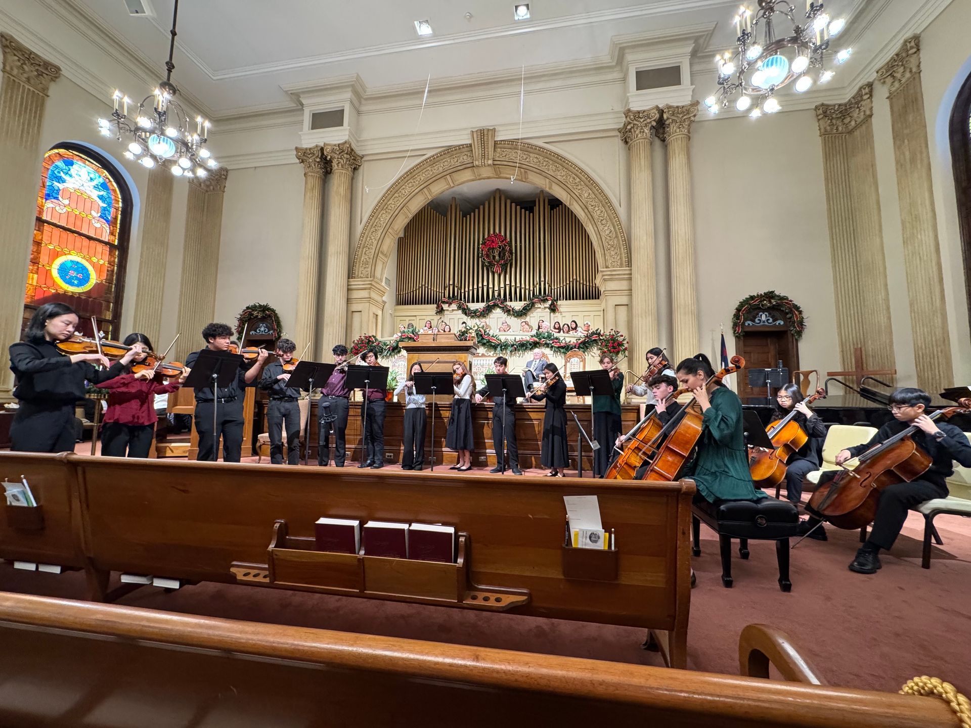 A group of Koart Academy students are playing instruments at First Baptist Church.