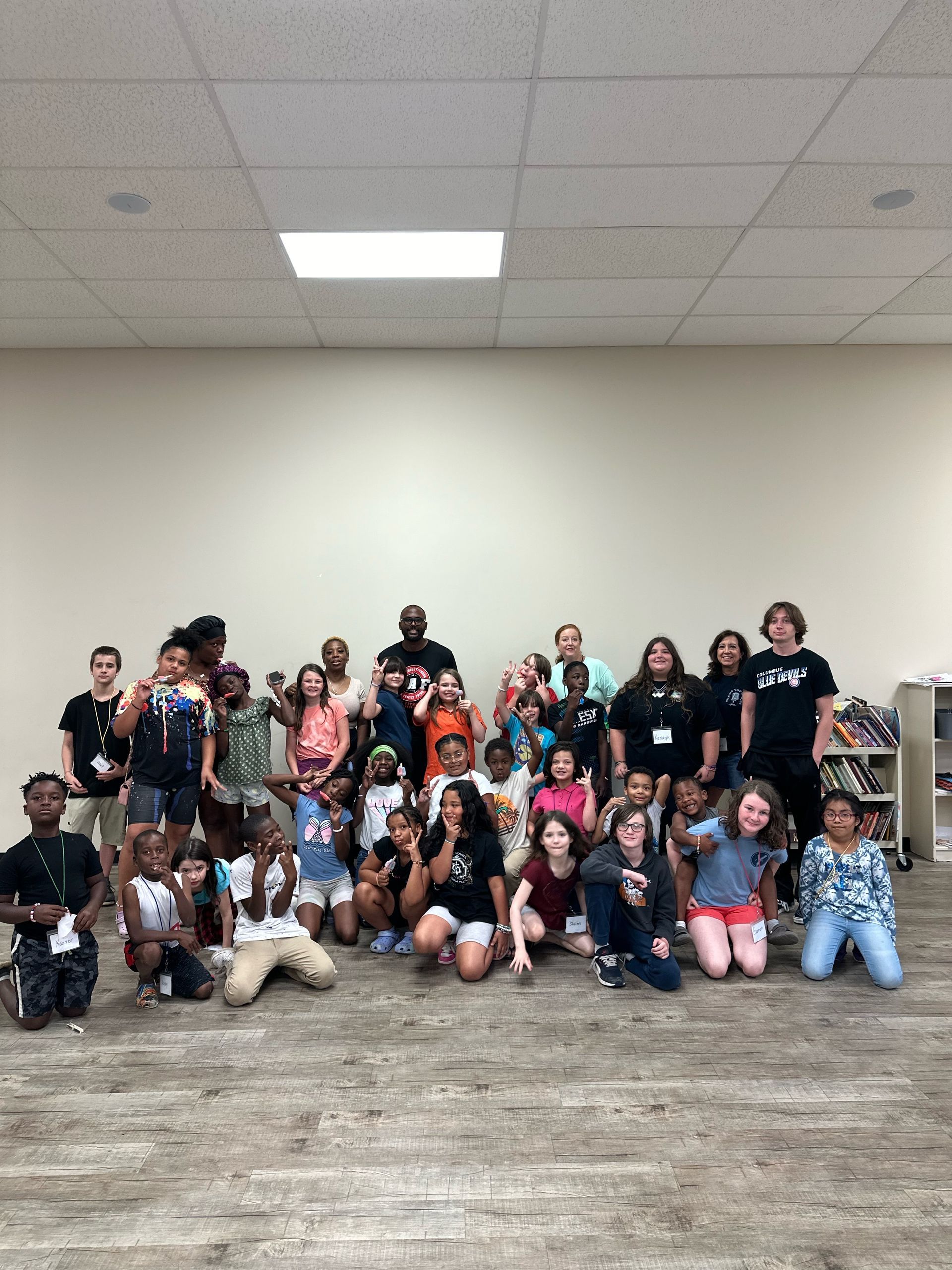 A group of children are posing for a picture in a room.