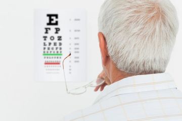 Senior man looking at eye chart - Eye Exams in South Gate, CA