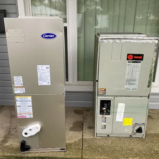 Two HVAC units on a concrete patio; a Carrier and a Trane unit are side-by-side.