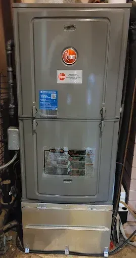 Gray Rheem HVAC unit with front access panels.