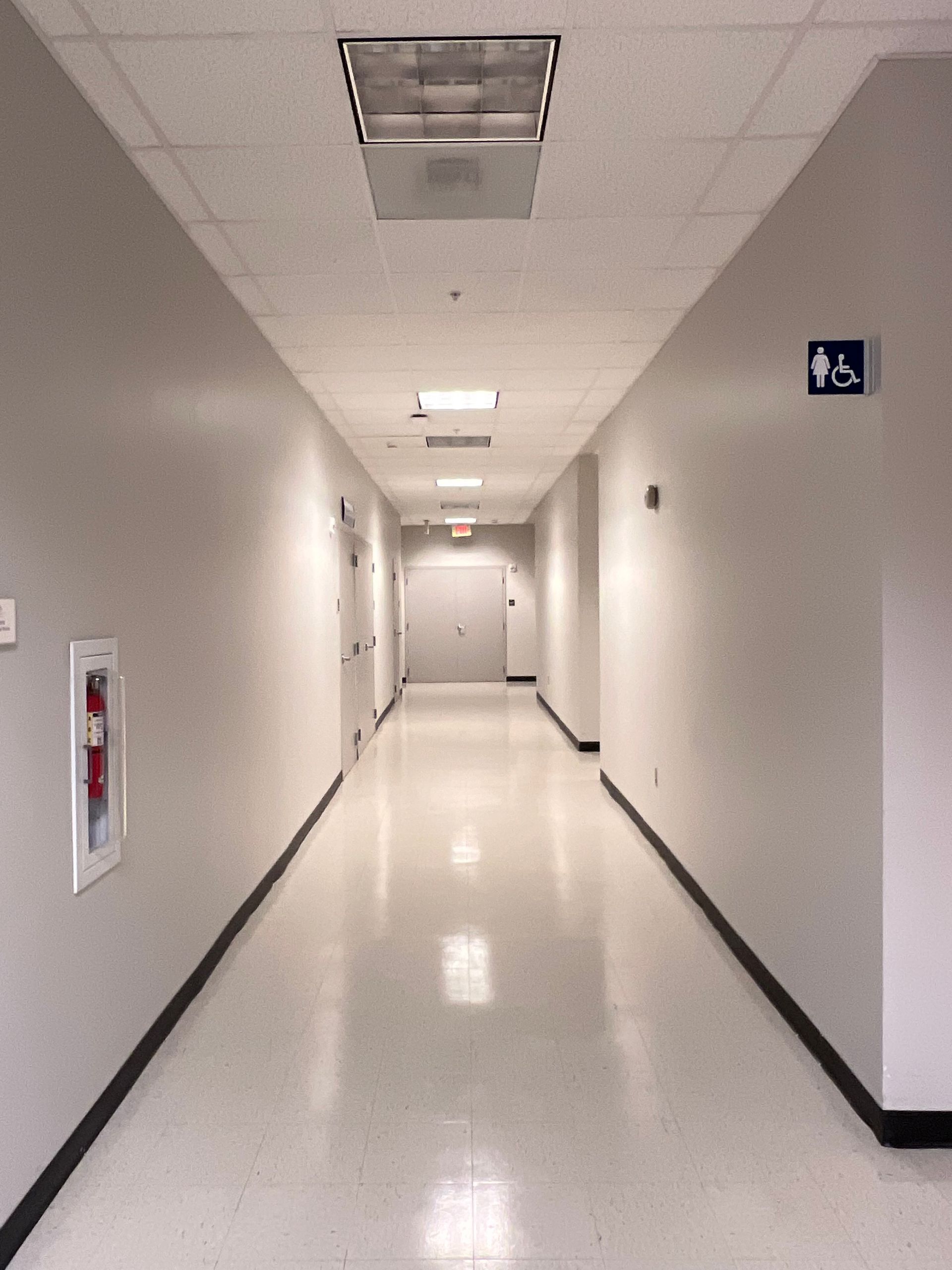 A long hallway with a handicap sign on the wall