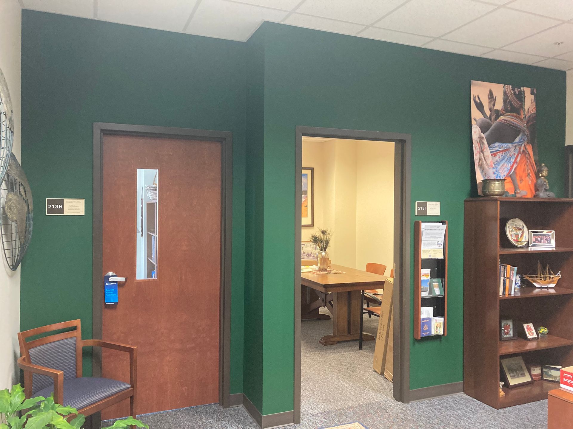 A room with green walls and a wooden door