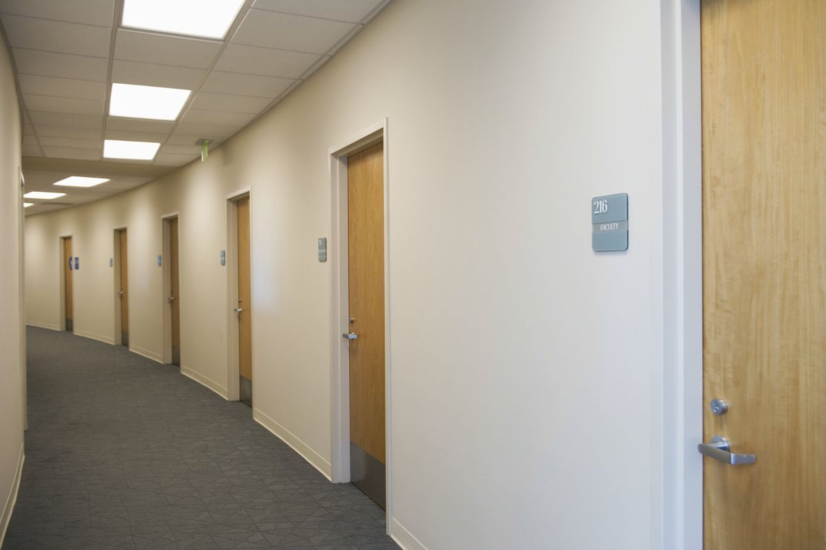 A long hallway with a handicap sign on the wall