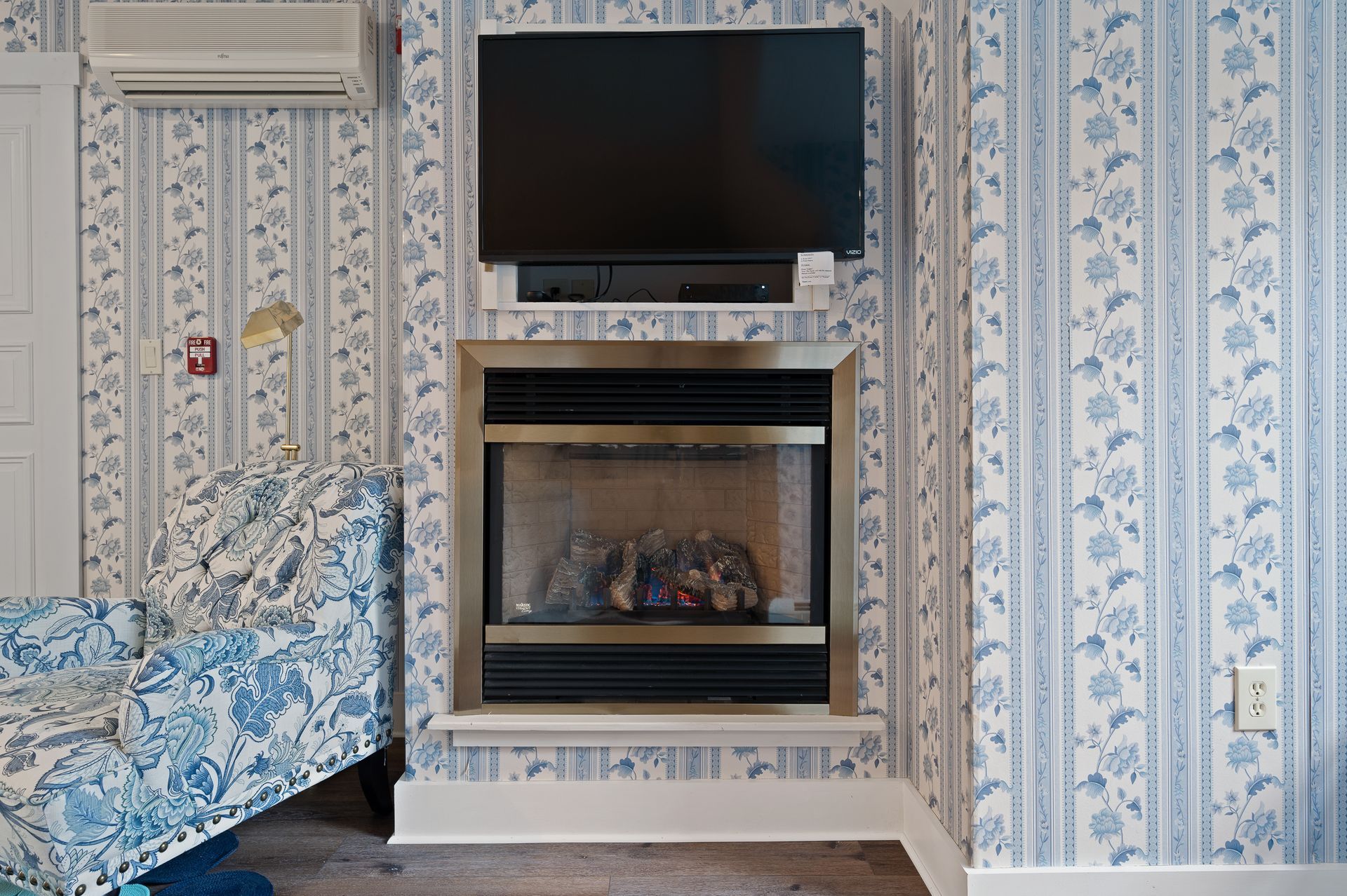 A living room with a fireplace and a flat screen tv
