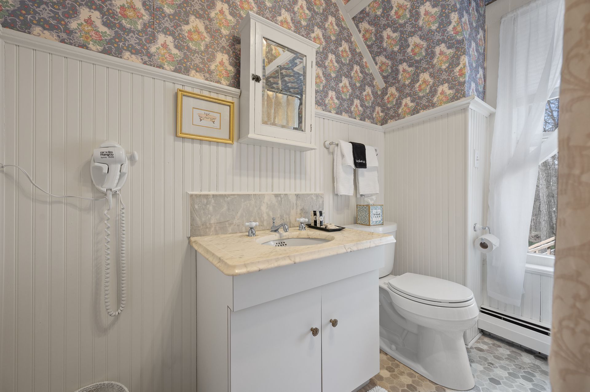 A bathroom with a sink , toilet , and mirror.