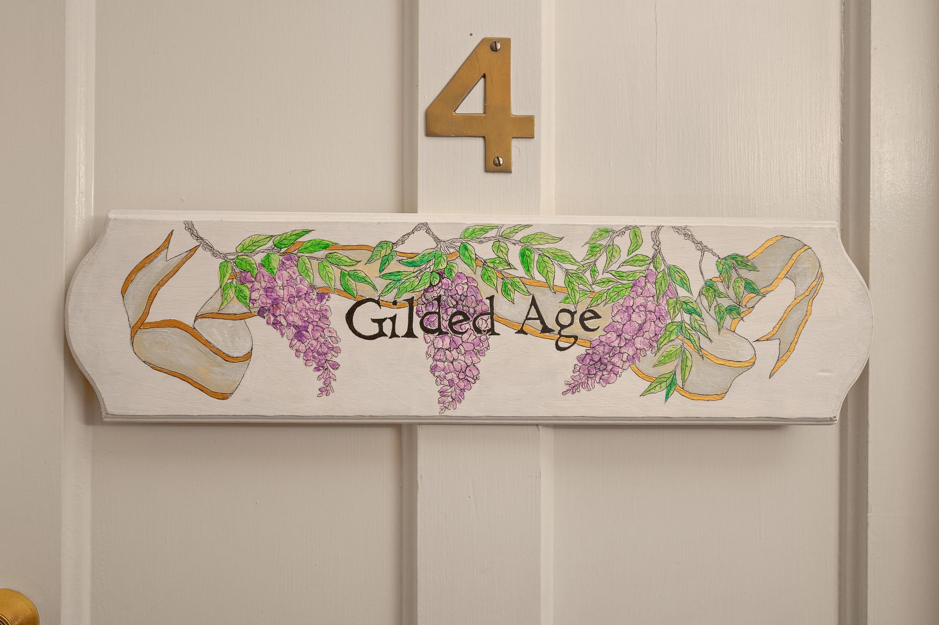 A sign on a door that says gilded age