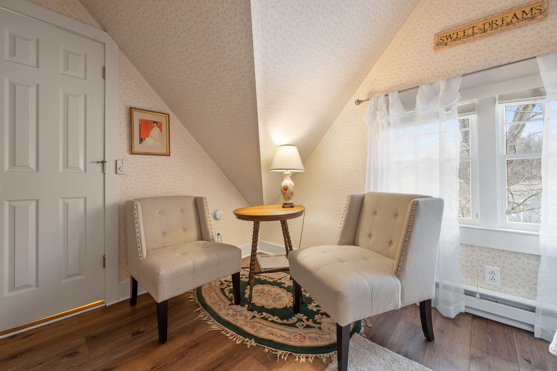 There are two chairs and a table in the room.