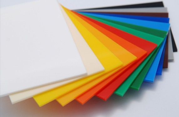 Colorful stack of acrylic sheets, ranging from white to black.