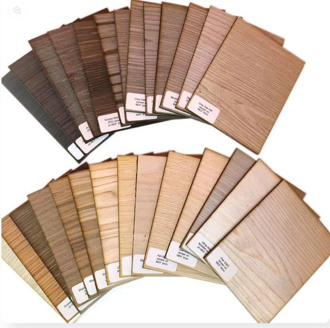 Woman working on a laptop and drawing on a tablet at a white table with flowers and coffee.