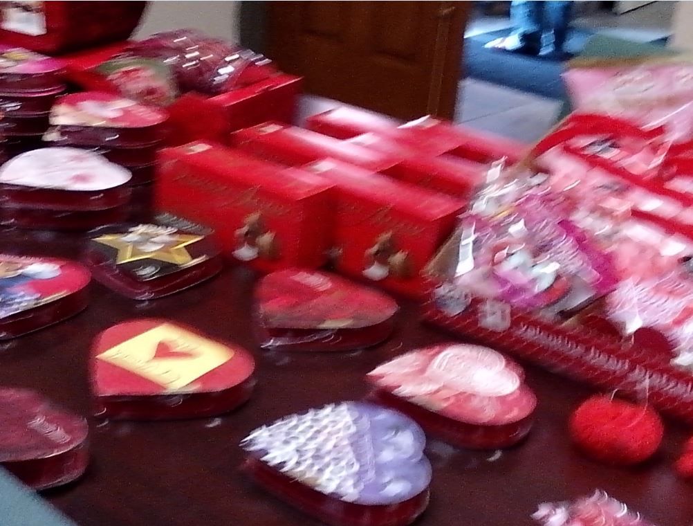 A table full of red boxes with hearts on them