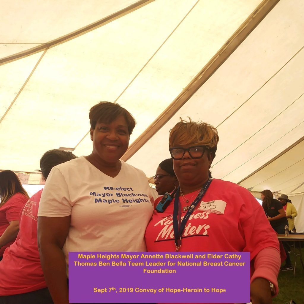 Two women are posing for a picture and one is wearing a shirt that says magic whales