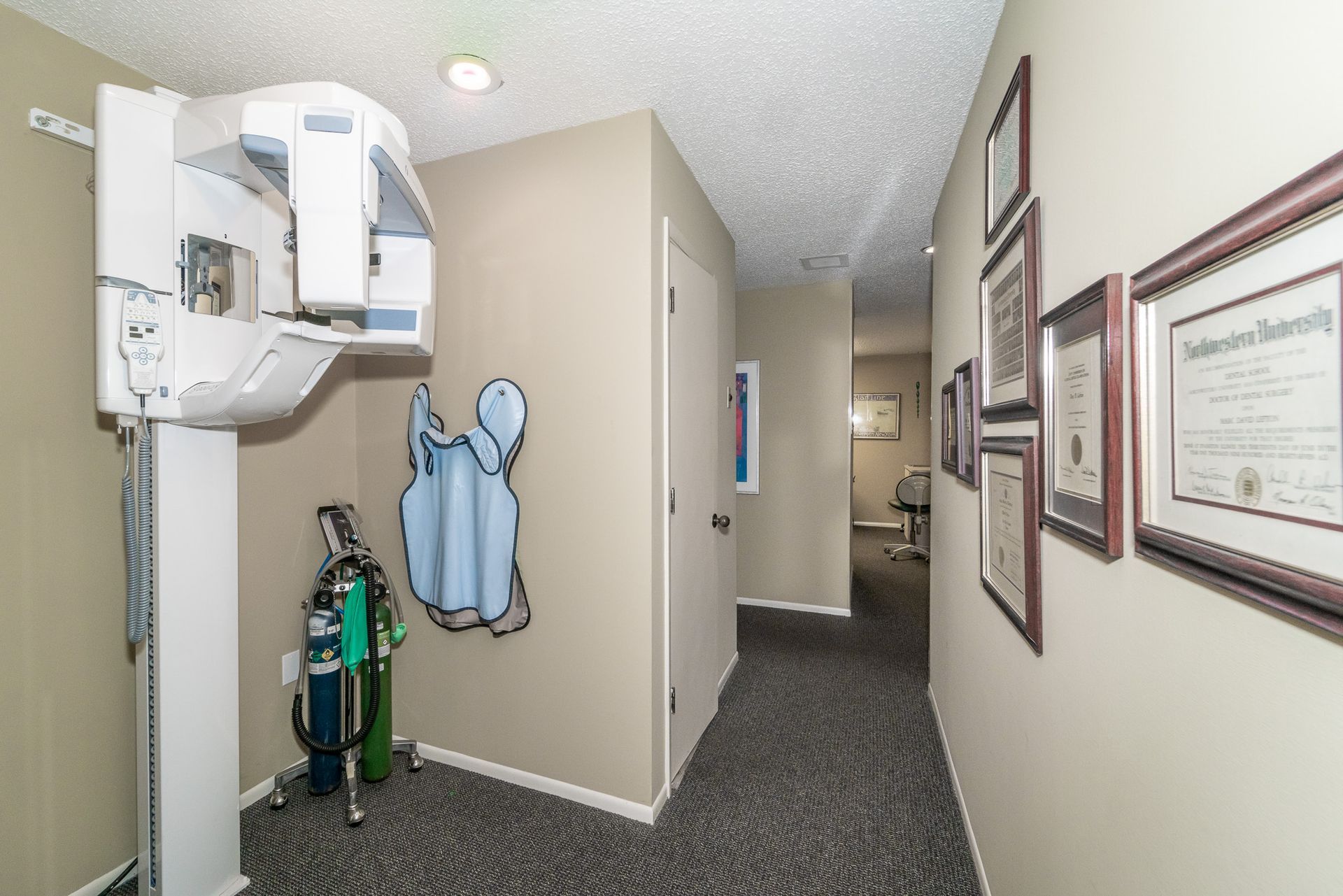 A hallway with a dental x-ray machine in the middle of it.