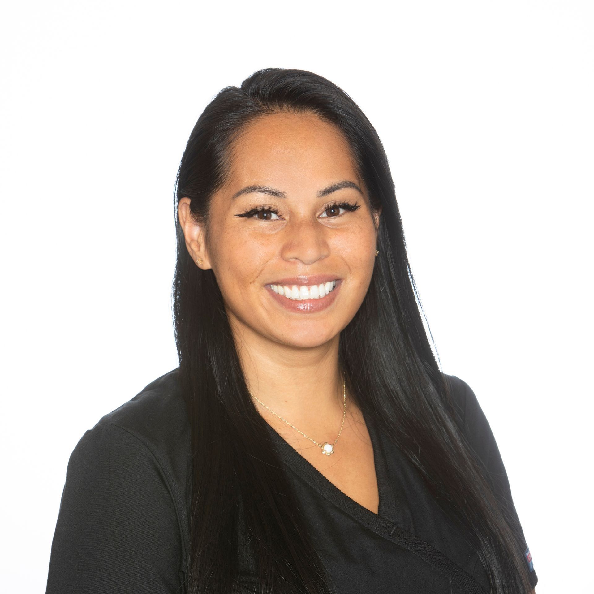 The woman is wearing a black shirt and smiling for the camera.