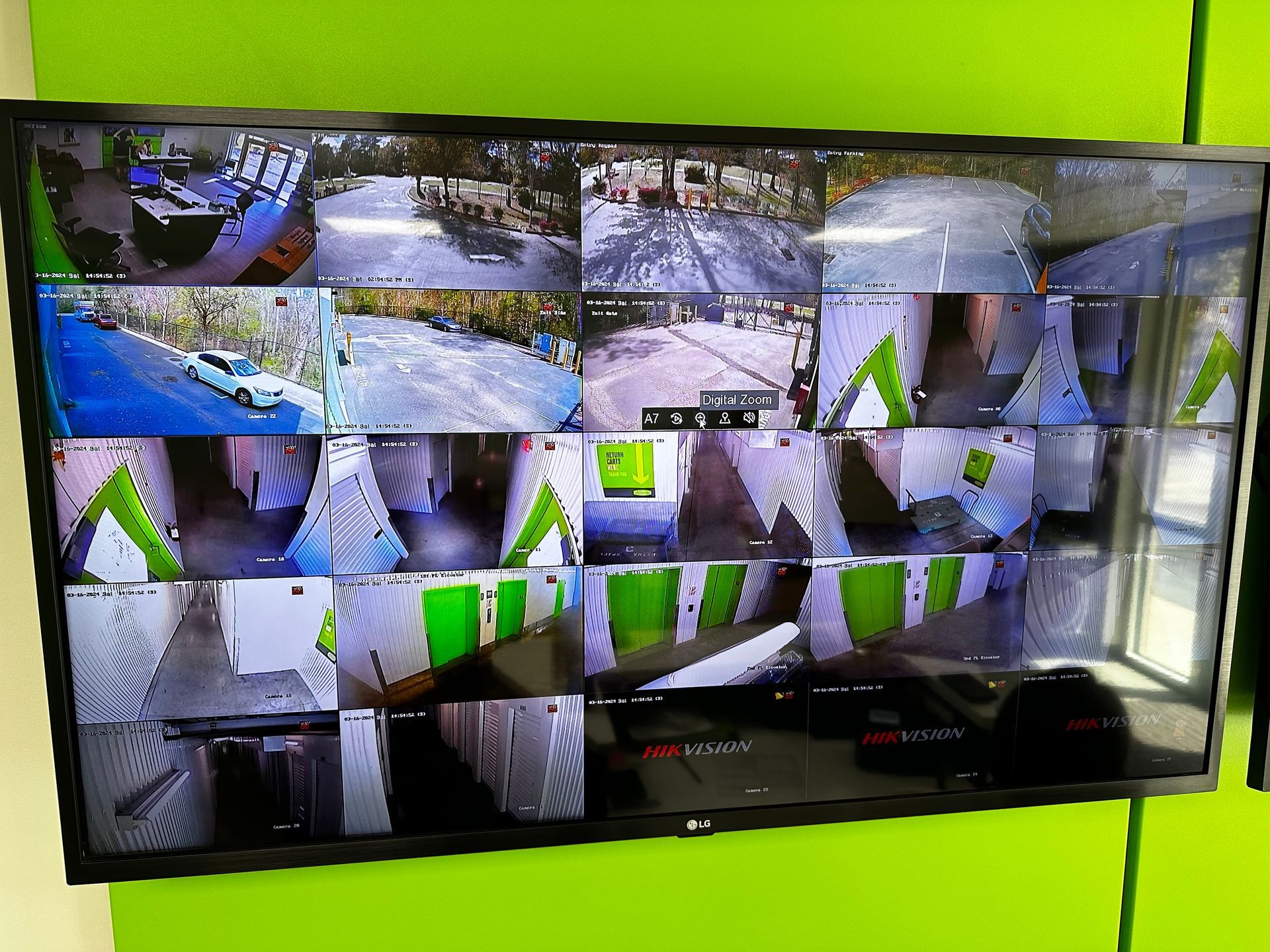 Security monitor displaying multiple camera views of an exterior and interior location.