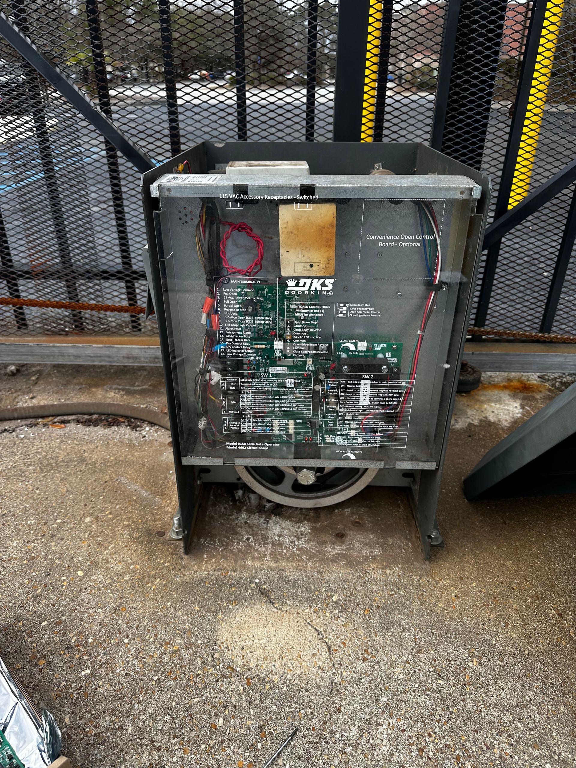 Open gate control box with circuit boards and wiring.
