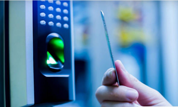 Hand with card near security device with fingerprint scanner; blue light.